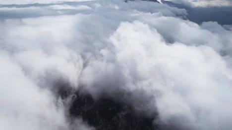 cloudy mountains, aerial drone flies above clouds in thermessos, antalya, turkey