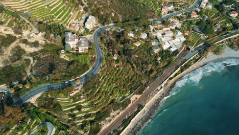 coastal landscape with roads, terraced fields, and train tracks