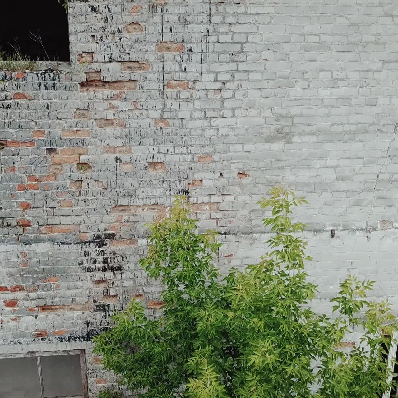Flying low over abandoned old plant. Ruins of abandoned old broken industrial factory.
