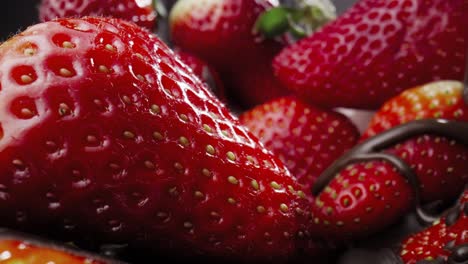 macro video of juicy strawberry covered with liquid chocolate