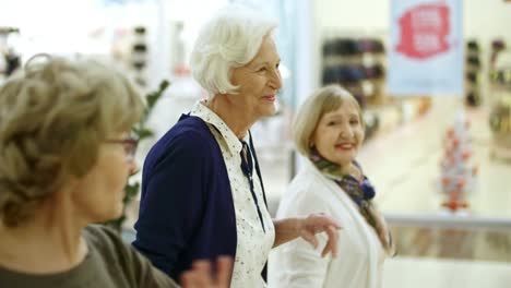 three elderly women shopping for clothes