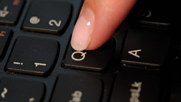 Black keyboard and a girl presses Q button