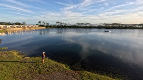 person fishing by a calm reflective lake