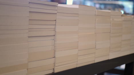 many stacks of books on display at a bookstore