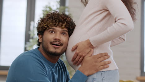 happy couple and pregnant woman