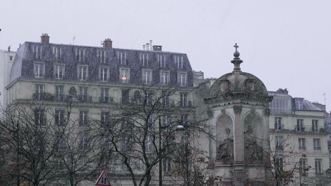 Snow falling in Paris at place Saint-Sulpice