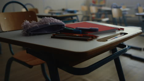 school supplies for education lying on desk. pens, pencils and notebook on table