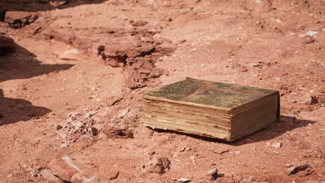 old book in red rock desert