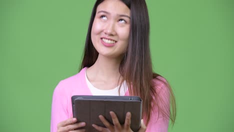 young beautiful asian woman using digital tablet