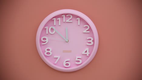 single pink clock on pink wall