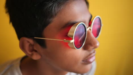 boy with red round sunglasses