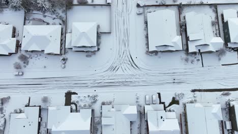 rising overhead view of houses covered in snow during an ice storm