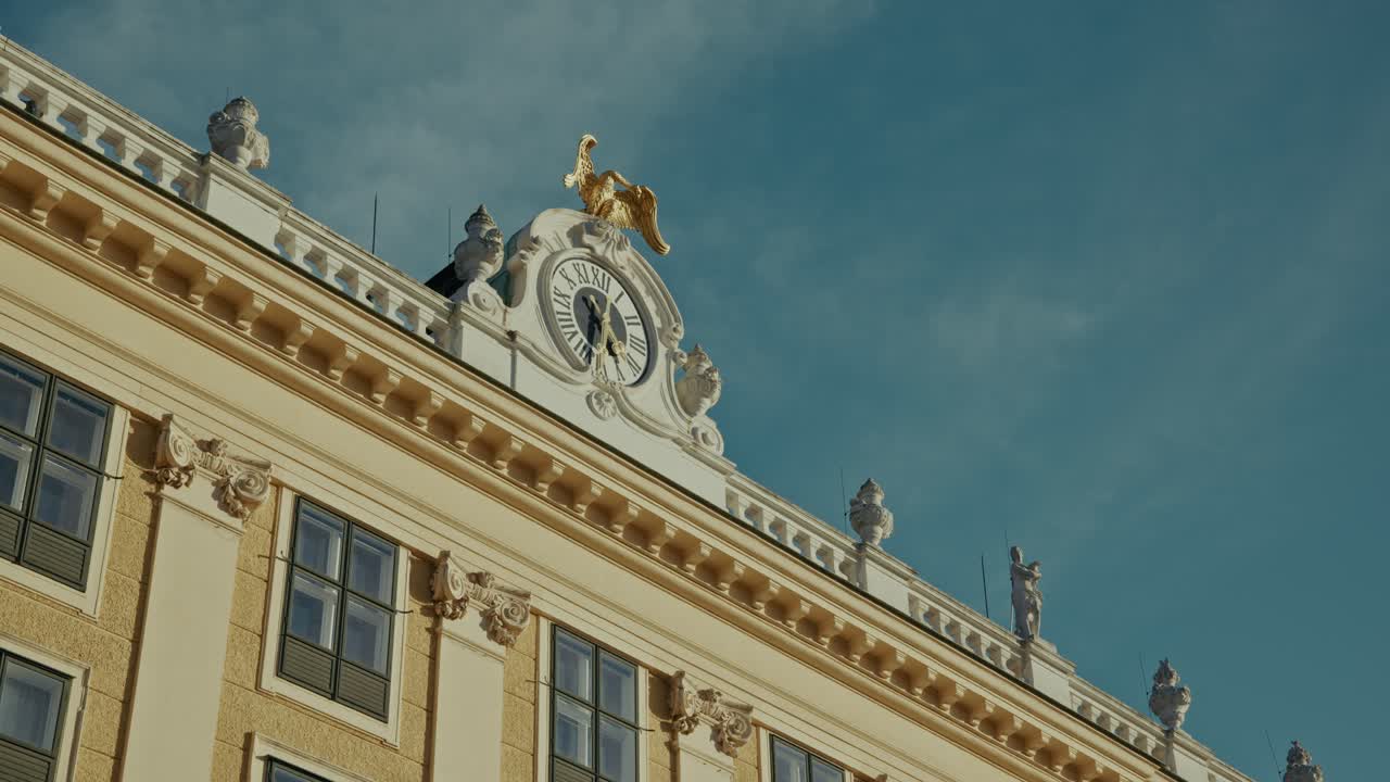 Golden eagle statue and clock on Schönbrunn Palace rooftop, Vienna, Austria