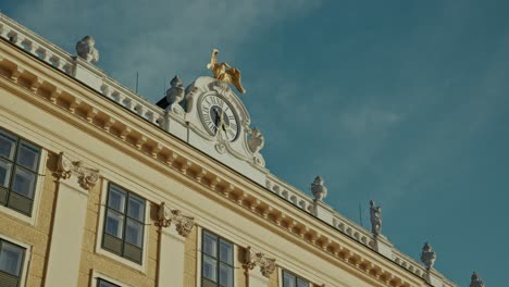 golden eagle statue and clock on schönbrunn palace rooftop, vienna, austria
