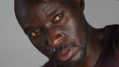 Portrait-of-sweaty-fit-african-american-man-exercising-inside-gym