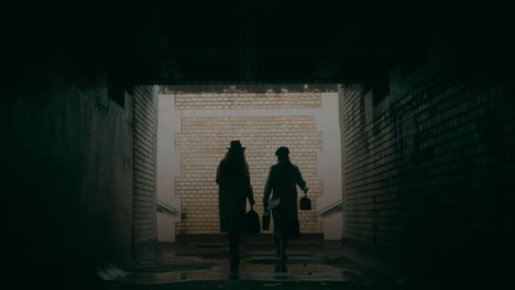 women walking in a tunnel