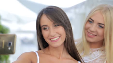 beautiful young girls make selfie girls make a photo beautiful young girls make selfie girls make a photo using a smartphone