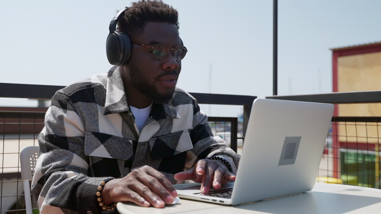 Man working on a laptop outdoors