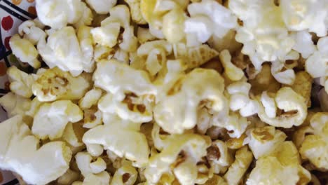 handheld pickup shot over popcorn in a bowl