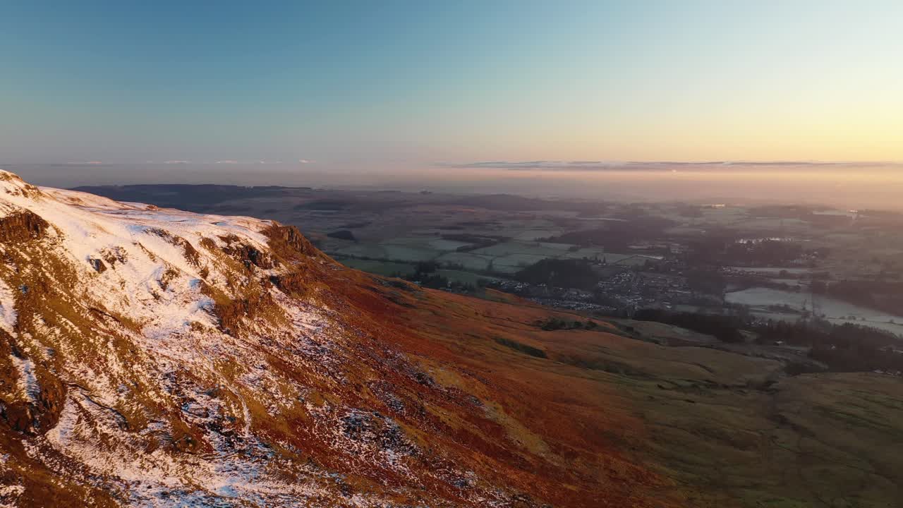 Aerial Majesty: Sunset Hues over Scotland's Timeless Campsie Fells, Scottish Hills and Countryside Near Glasgow, Scotland, United Kingdom