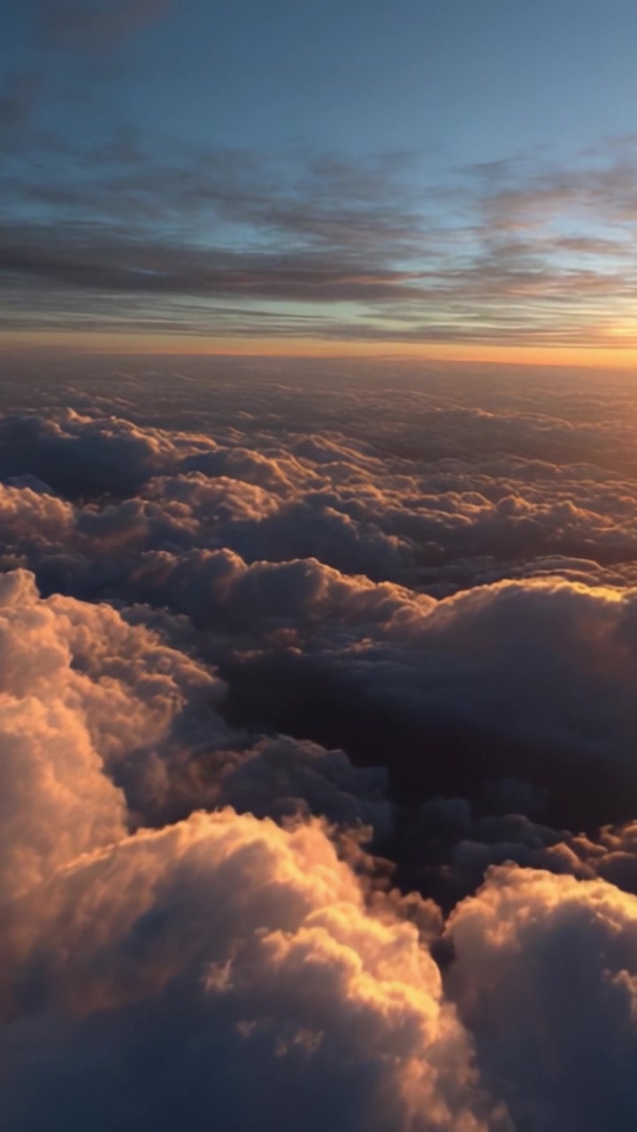 Stunning Aerial View of Colorful Clouds at Sunset with Rich Textures and Warm Hues Illuminating the Sky Above with a Soft, Ethereal Glow