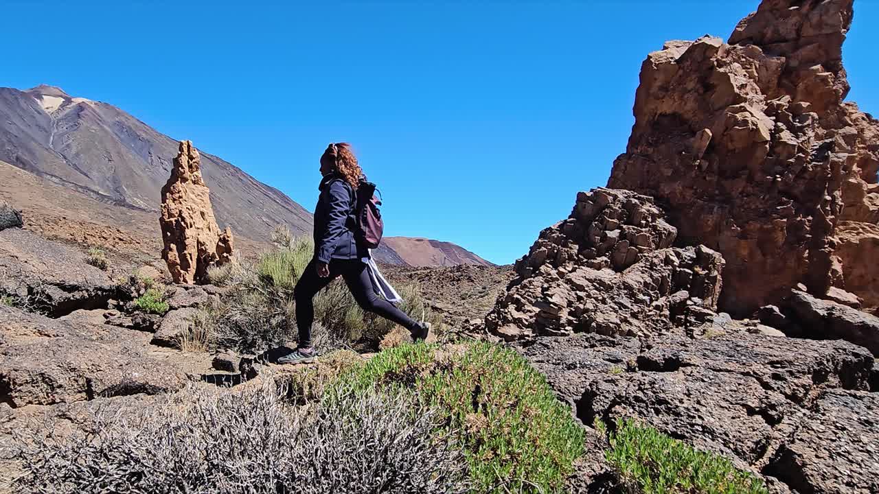 Hiker exploring volcanic landscape at Roques de Garcia, Tenerife, Spain