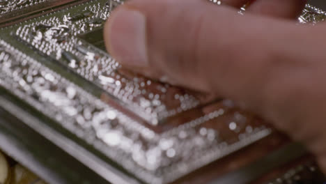 brown hand opening fancy silver box with cashew nuts inside, close up, slo w motion stable shot, 4k