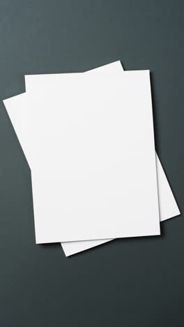 vertical video of books with white blank pages and copy space on black background