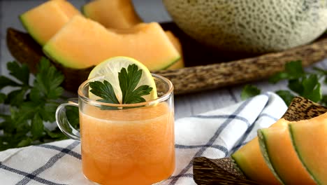 whole and sliced of japanese melons,honey melon or cantaloupe (cucumis melo) glass of melon smoothie healthcare concept.