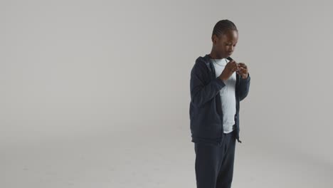 Studio-Shot-Of-Boy-On-ASD-Spectrum-Using-Sensory-Chew-Toy-To-Calm-Himself-And-De-escalate-Anxiety-