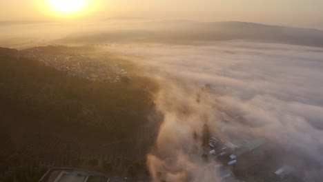 sunrise over a valley with fog