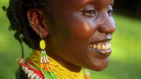 close up of african woman with smiling face wearing colorful beaded accessories