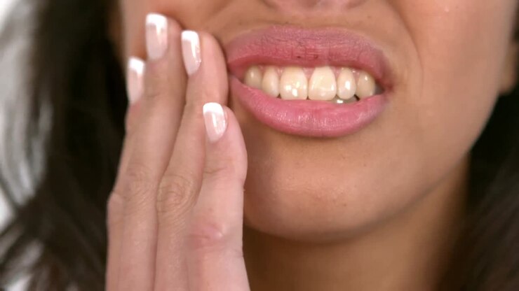 Casual woman getting a tooth ache