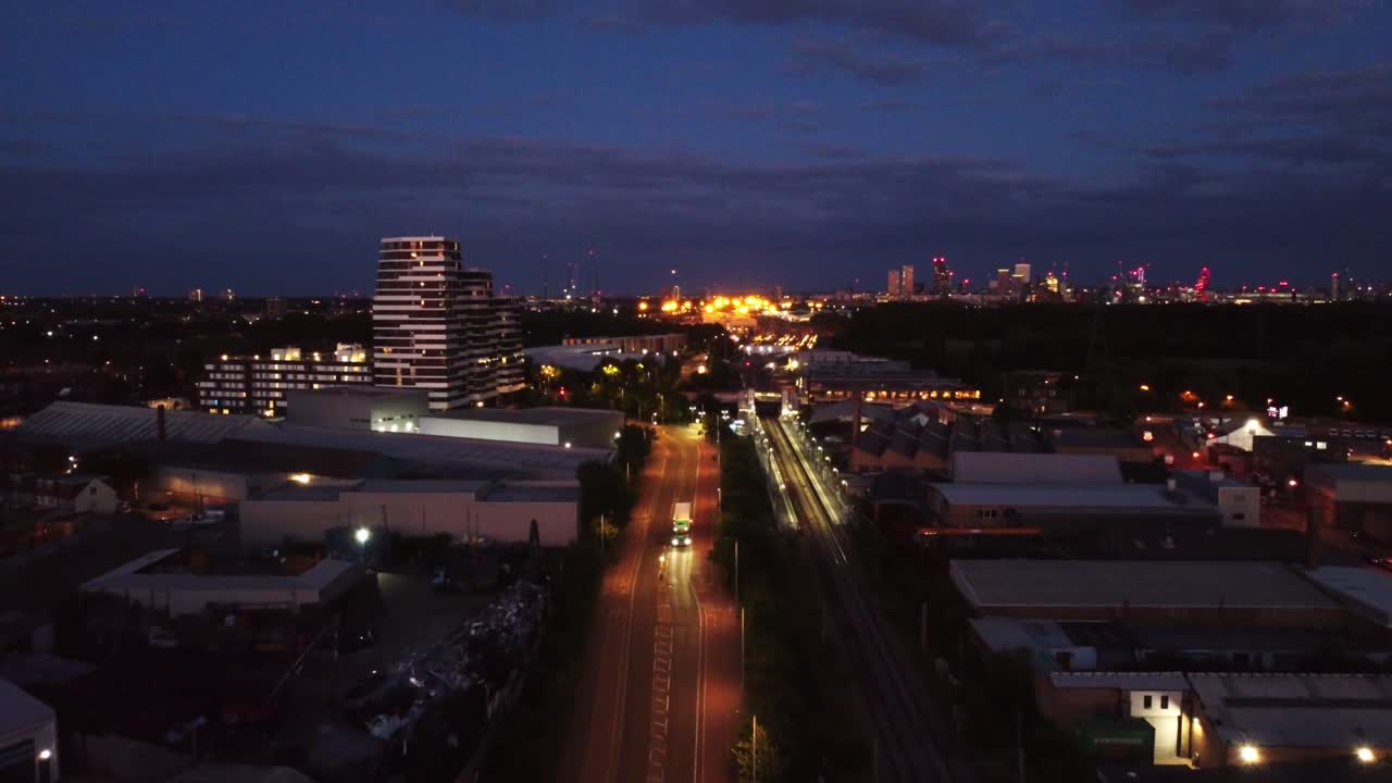 Wide angle aerial panorama of East London skyline at night, England