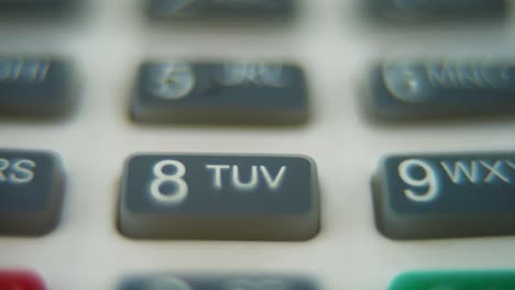 a macro close up shot of a pin pad numbers and letters on colorful buttons, smooth pull back movement, full hd video, super slow motion, blurry depth of field