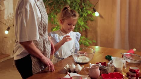 grandmother and granddaughter baking together