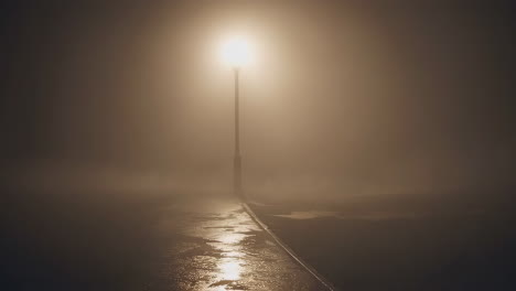 lamppost in dense fog at night