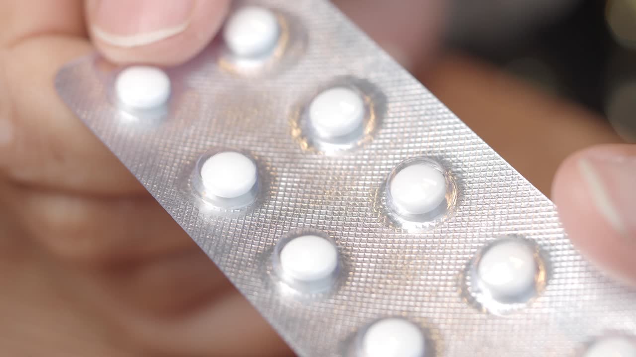 Hand holding a blister pack of pills