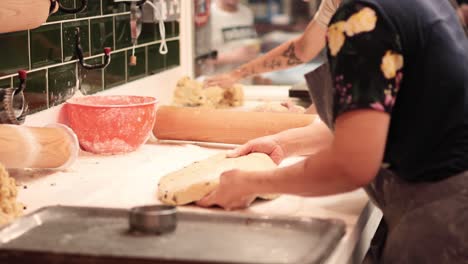 baker kneading dough in cardiff market