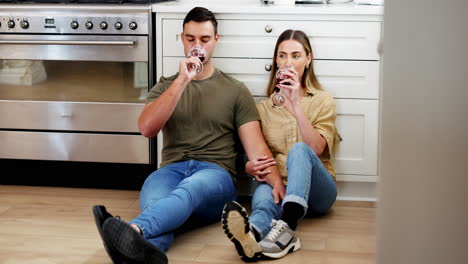 couple on floor in kitchen with wine