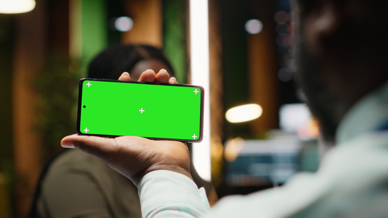 Staff members in a discussion after hours next to copy space on smartphone