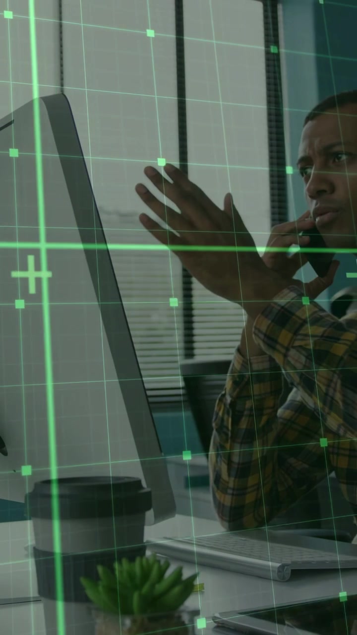 Vertical video: Businessman on phone, reading monitor while green grid appearing guiding call