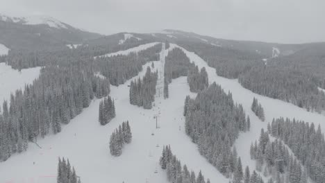 copper mountain covered in thick snow after heavy snowstorm in colorado, usa. drone shot.