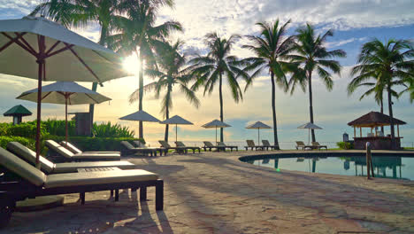 umbrella and chair around swimming pool in resort hotel for leisure travel and vacation neary sea ocean beach at sunset or sunrise time