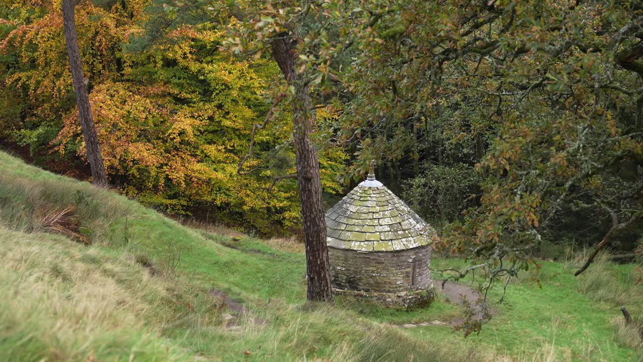 Historic stone shrine in Goyt Valley, Peak District surrounded by forest