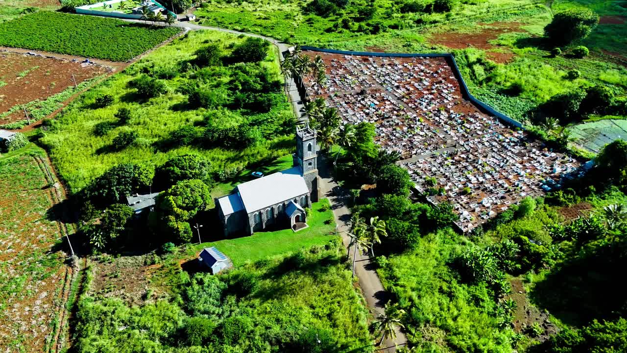 Aerial view of small green village area in Mauritius surrounded by lush fields and tropical vegetation