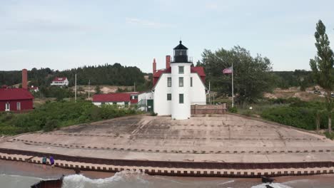 historic point betsie lighthouse in frankfort, michigan located along lake michigan with drone video flying overhead