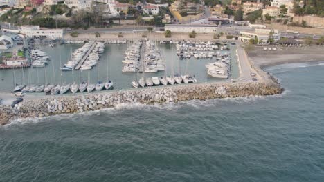 Sail-boats-yachts-in-harbour-port,-vessel,-static-aerial-shot-overview-topview-drone,-luxury-europe,-cannes,-larcarna,-kesrouane,-salou,-santorini,-blue-ocean,-turquoise-water,-sea-beach-mediterranean