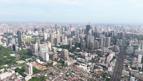 drone view of bangkok, some skyscrapers, highway and greenery.