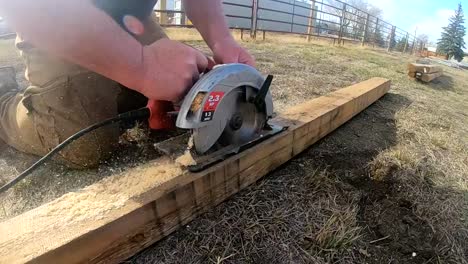 slow motion - cutting a 4x4 wooden post with a circular saw